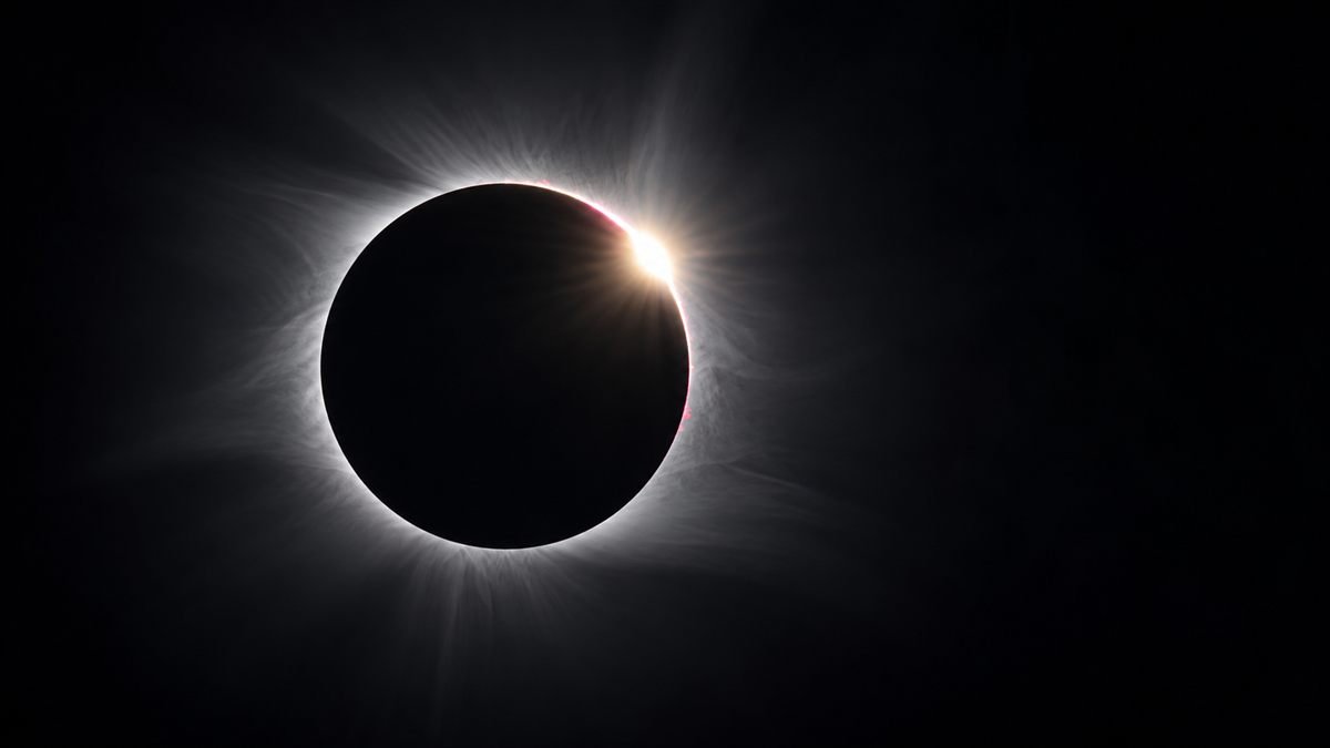 The diamond ring effect during a total solar eclipse, a brilliant point of light against the corona at the edge of the Moon's silhouette