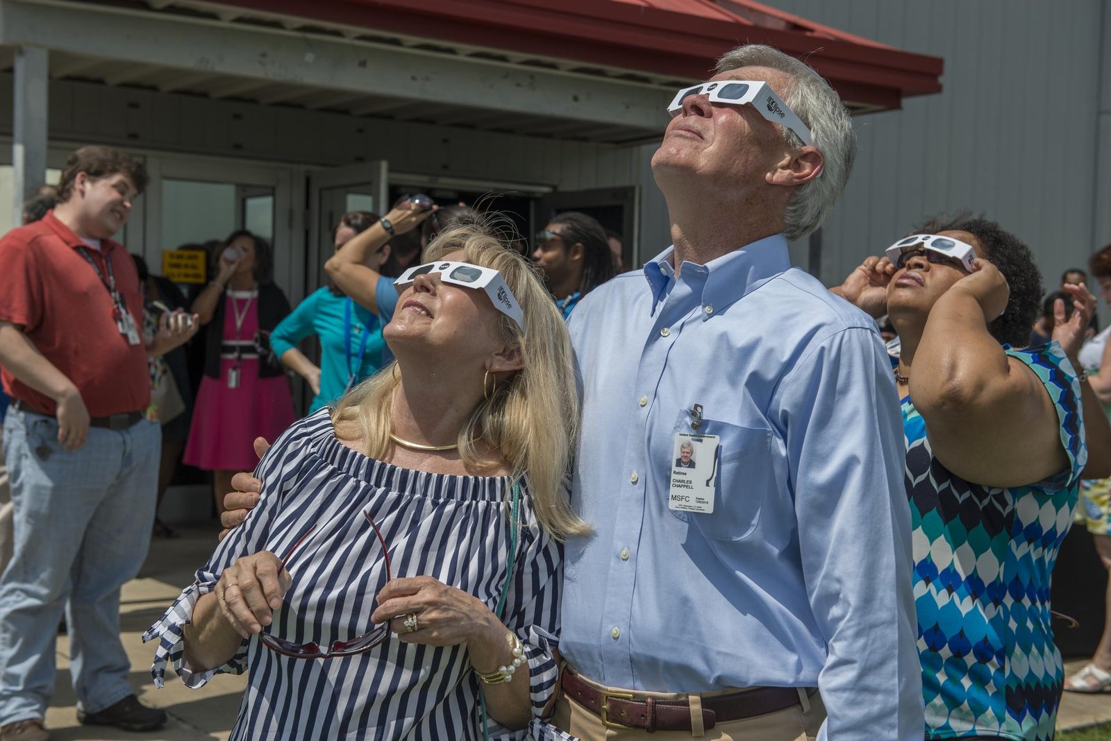 A group wearing ISO-certified eclipse glasses safely observes a solar eclipse